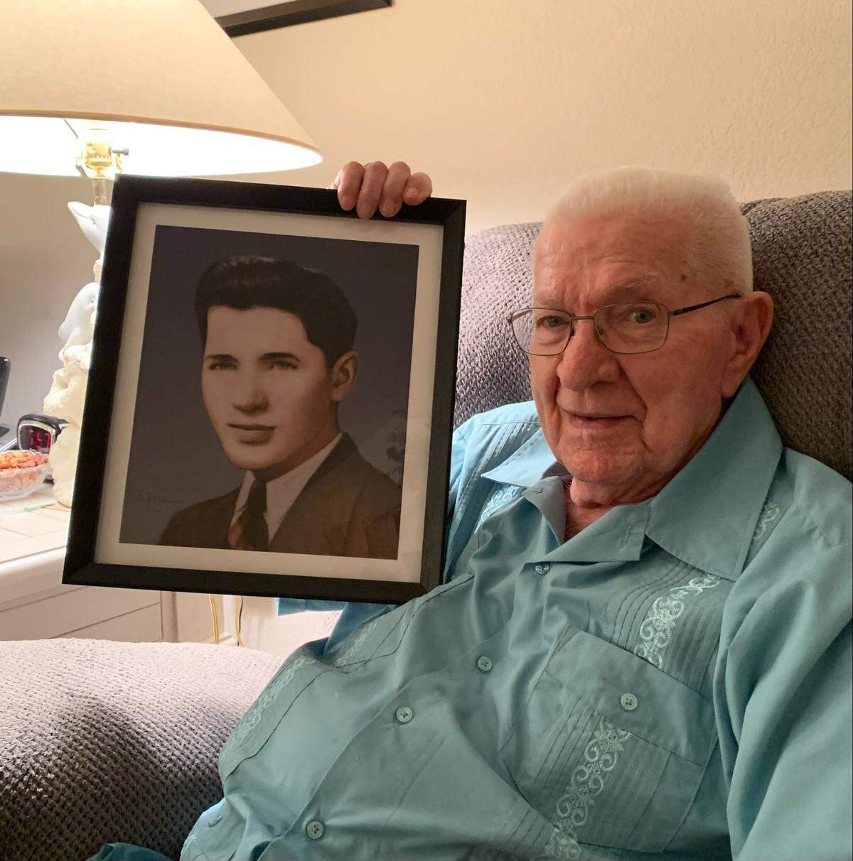 Milton Dahler holds a graduation picture of himself a gift given by his son Mark Dahler.