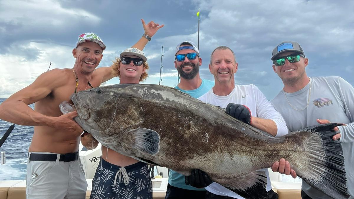 From left, members of Team Sick Leave Gabriel Lippert, AJ Grande, Brandon Anderson, Don Paxton and Dawson Day pose with their winning black grouper during the 2022 Sarasota Slam.