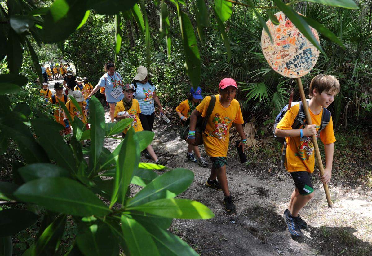 Cub Scouts make their way down a trail at Camp Flying Eagle during the Boy Scouts of America Manatee District 2013 Cub Scout Day Camp. The camp had more than 275 cub scouts participating in the week-long camp. The theme was the Wild Wild West and the Hunt for Black Bart.