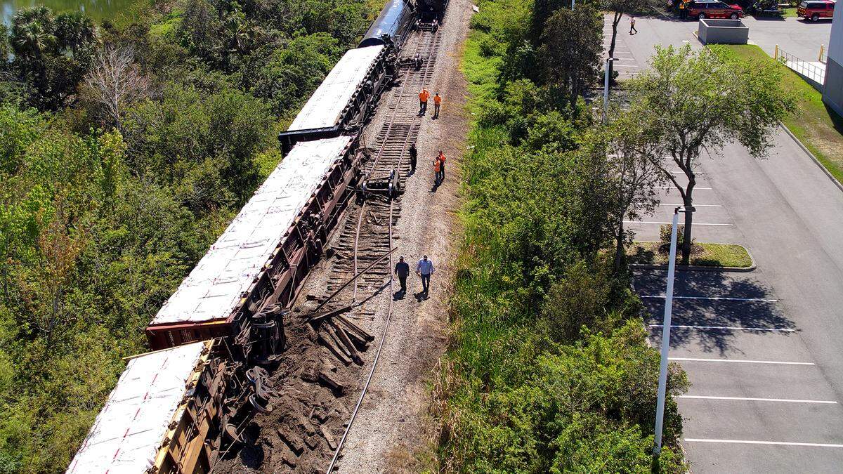 Workers inspect a Seminole Gulf Railways train that derailed in Bradenton Feb. 28, 2023.