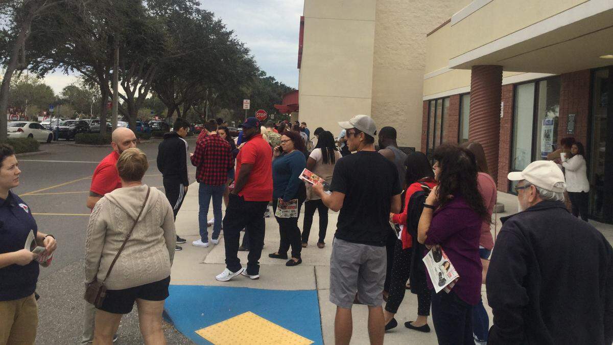 About 100 people line the sidewalk leading up to Target during early Black Friday shopping on Thanksgiving evening.