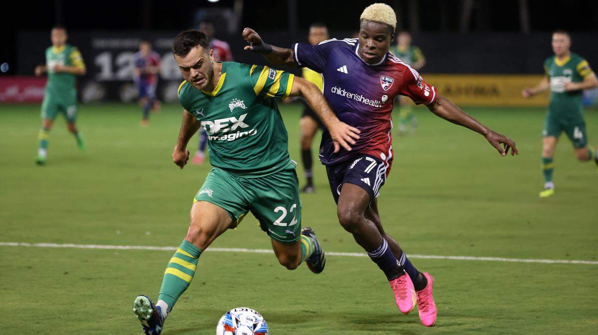 May 22, 2024; St. Petersburg, Florida, USA; Tampa Bay Rowdies midfielder Jordan Doherty (22) defends FC Dallas forward Bernard Kamungo (77) during the second half at Al Lang Stadium. Mandatory Credit: Kim Klement Neitzel-USA TODAY Sports