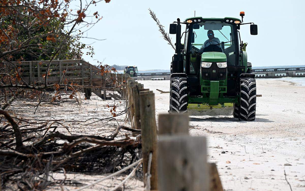 Tractors clean the sand on Cortez Beach in Bradenton Beach after Hurricane Helene on Oct. 2, 2024.