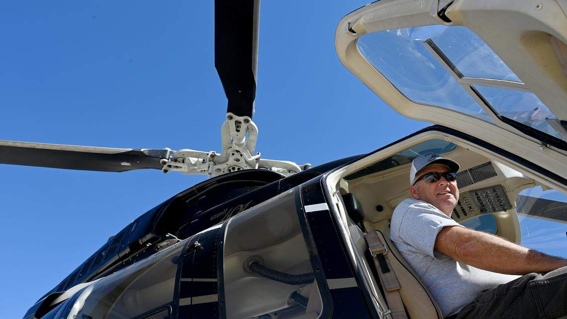 Chief pilot Mike McCraw of Manatee County Mosquito Control District and one of the helicopters used to spray malathion to kill mosquitos.