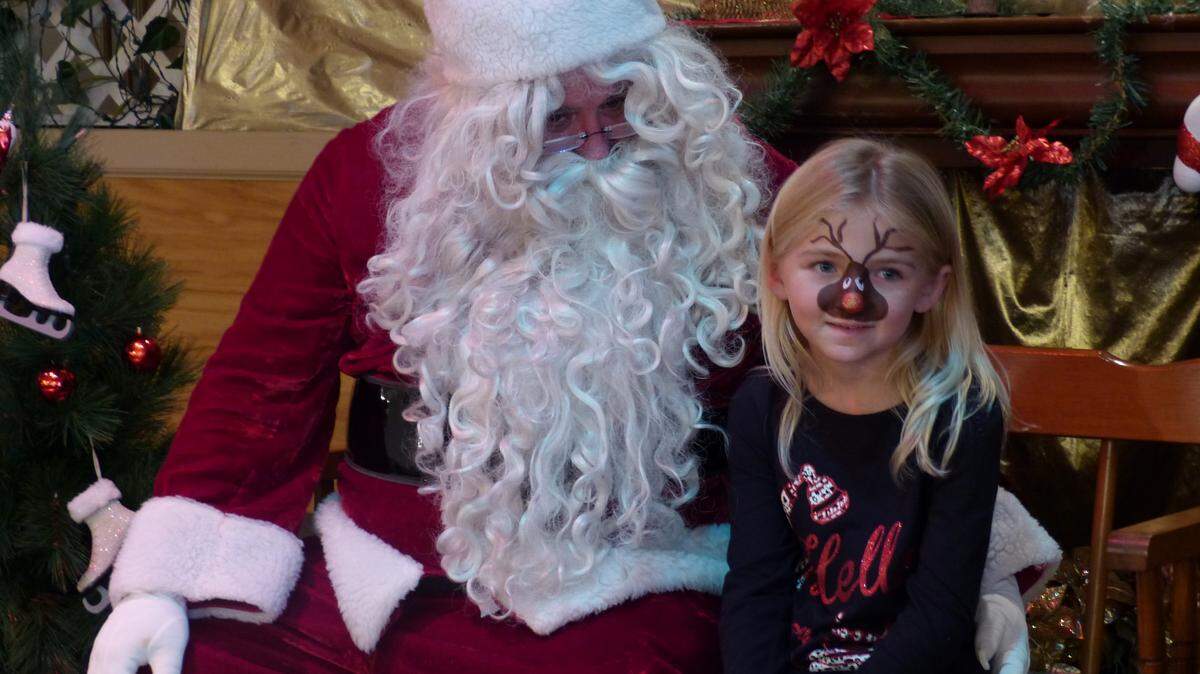 Cheyenne Carpenter, 7, visits with Santa at the Bradenton Elks Lodge's children's Christmas party on Sunday. The party is held for families from Turning Points, a local organization dedicated to helping the homeless.PHOTOS BY JANELLE O'DEA/Bradenton Herald