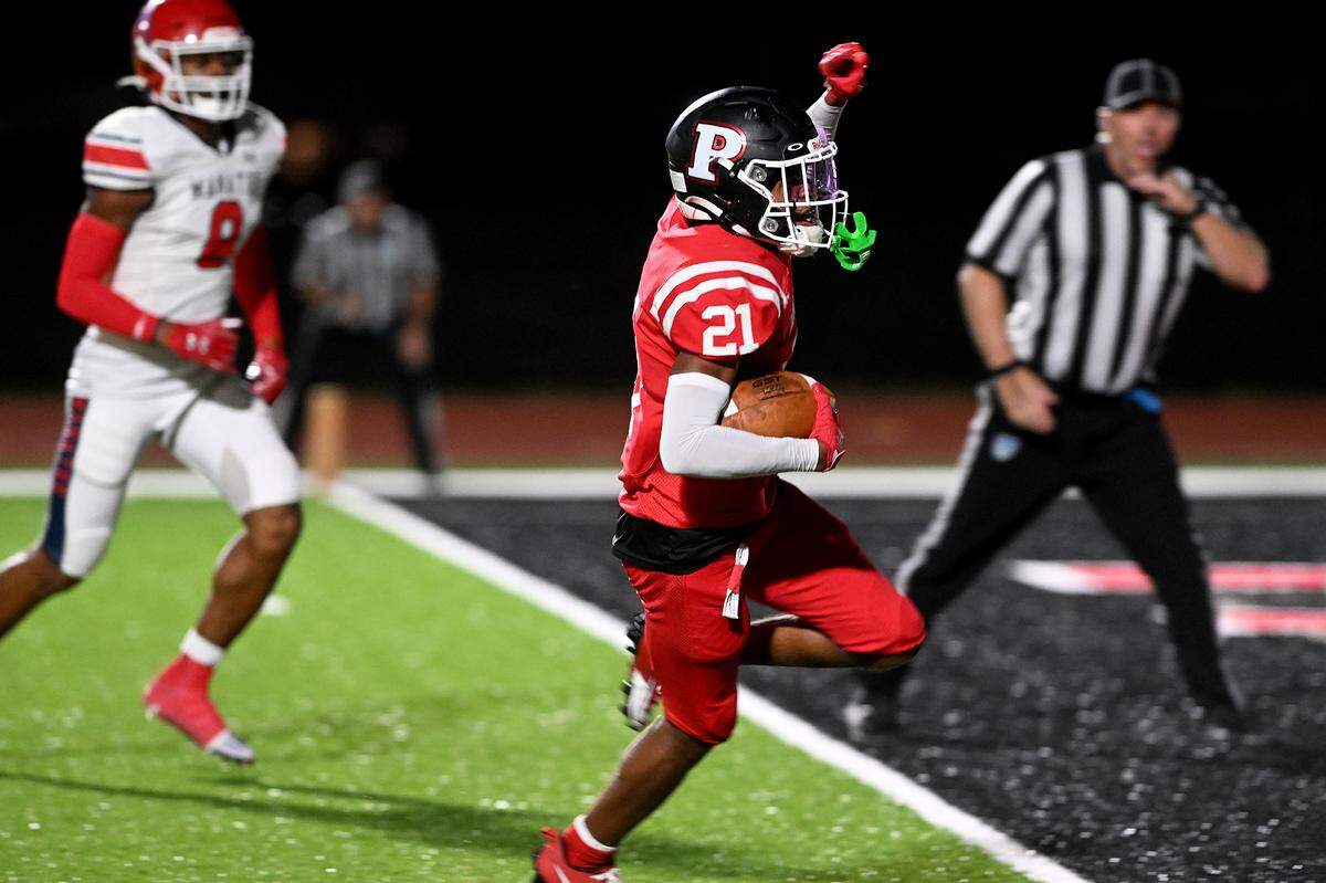 Palmetto’s #21 celebrates a touchdown as he approaches the end zone against Manatee on Friday, Oct. 27, 2023 in Palmetto.