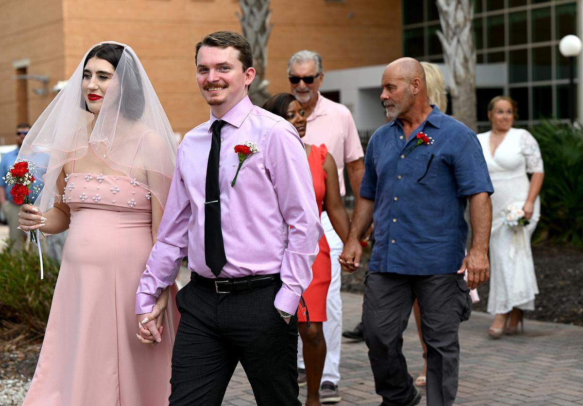 Zachary Masengale smiles as he walks with his bride, Samantha Whitt.