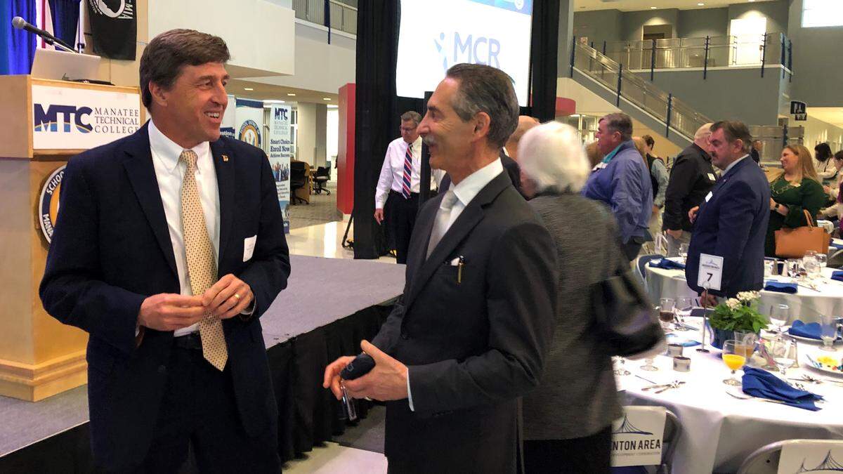 Kevin DiLallo, CEO of Manatee Healthcare System, left, talks to economist Hank Fishkind Thursday at Manatee Technical College. Fishkind had just presented his economic forecast to the Bradenton Area Economic Development Corp.