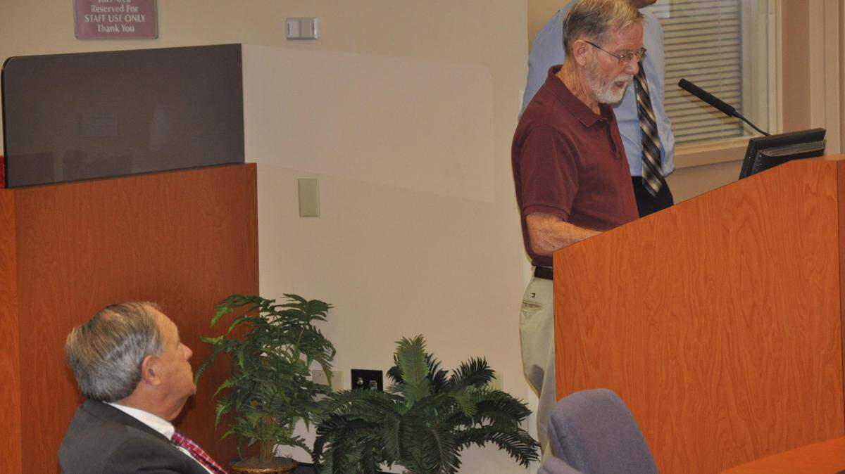 Manatee County School Board member Dave Miner, left, listens as county resident Ed Goff expresses his support for school impact fees, during a meeting Thursday of the county Planning Commission. The commission voted unanimously to recommend that the county commission next month approve the fees. MARC R. MASFERRER/Bradenton Herald.