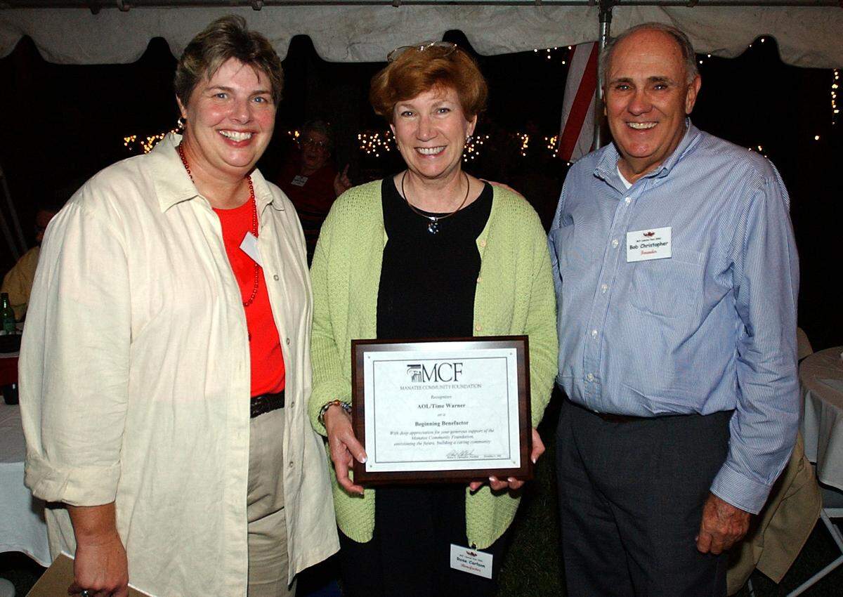 In this Bradenton Herald archive photo, past Manatee Community Foundation CEO Marilyn Howard, left, and and past MCF president Bob Christopher, right, pose with Rose Carlson of Time Warner Communications, center, who accepted a “Beginning Benefactor” plaque at the MCF Lobsterfest in 2002.