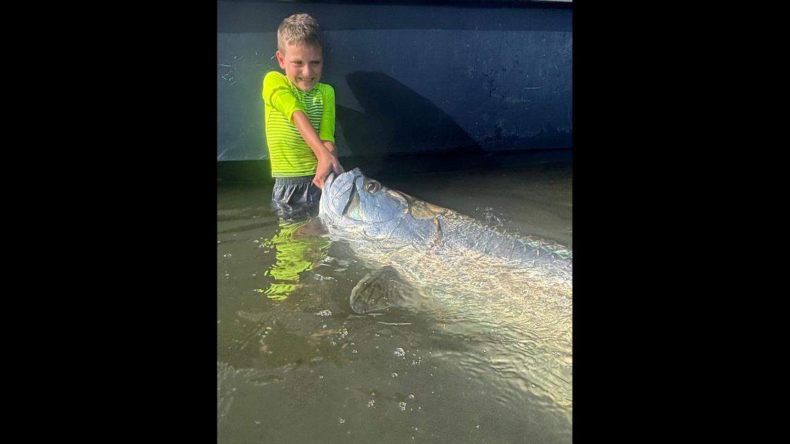 Palmetto 7-year-old poses with massive tarpon on fishing trip with dad