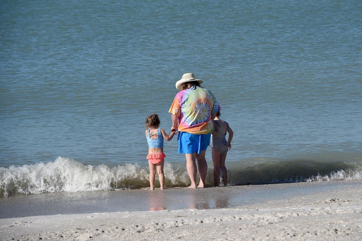 Beach-goers enjoy a beautiful day at Manatee Public Beach on Monday with no visible signs of red tide.
