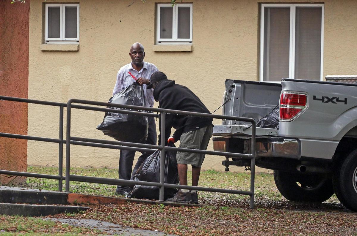 Executive director of Bradenton Housing Authority, Ellis Mitchell Jr., left, who has been accused of harassment and abusive behavior, gets assistance in clearing out a house where a tenant was evicted. A group of current and former tenants came together on Wed. March 16, 2022, to protest Ellis Mitchell Jr. and his leadership of the Housing Authority of the City of Bradenton.