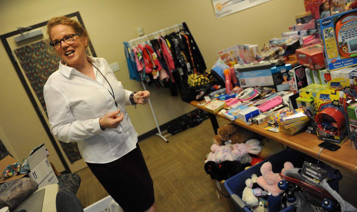 Laurel Lynch, CEO of Hope Family Services, shows her excitement as she looks at toys that were donated in 2015 for the families of domestic violence victims GRANT JEFFERIES/Bradenton Herald