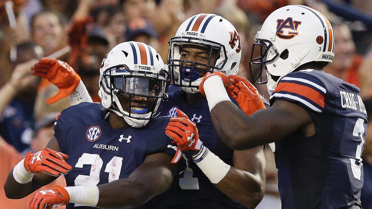 IMG Academy wide receiver Michael Redding III tweeted he picked up another SEC college football offer. The rising junior received it from Auburn. In this Sept. 2, 2017, file photo, Auburn running back Kerryon Johnson, left, wide receiver Darius Slayton, center, and wide receiver Nate Craig-Myers, right, celebrates Johnson's touchdown in the first half of an NCAA college football game against Georgia Southern, in Auburn, Ala. Kerryon Johnson was selected to the AP All-Conference SEC team announced Monday, Dec. 4, 2017.
