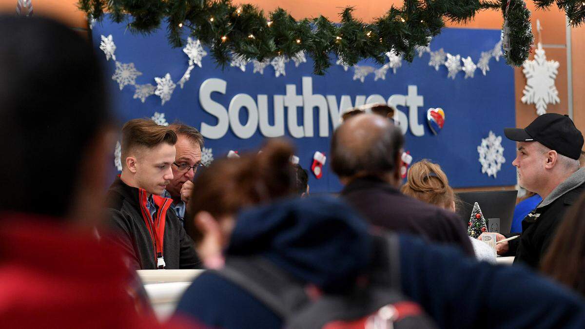 Passengers line up at the ticket counters at the Sarasota Bradenton International Airport where 13 arrivals and 12 departures were cancelled on the morning of Dec. 27, 2022.