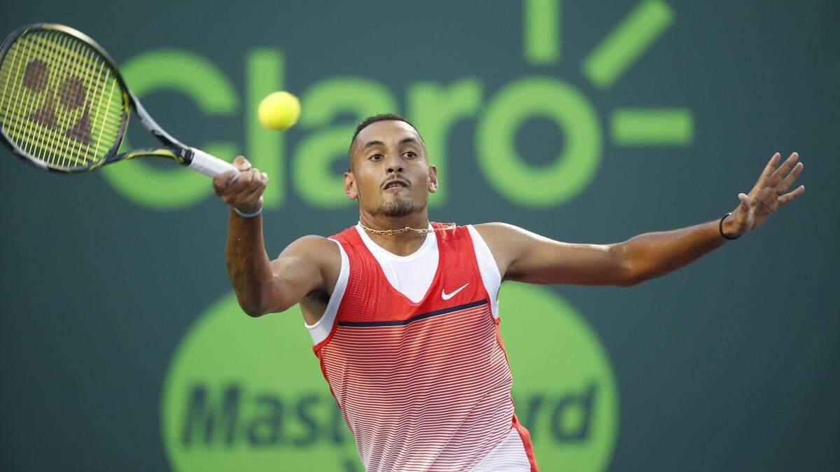 Nick Kyrgios, of Australia, returns a shot from Kei Nishikori, of Japan, at the Miami Open tennis tournament, Friday, April 1, 2016, in Key Biscayne, Fla. (AP Photo/Wilfredo Lee)