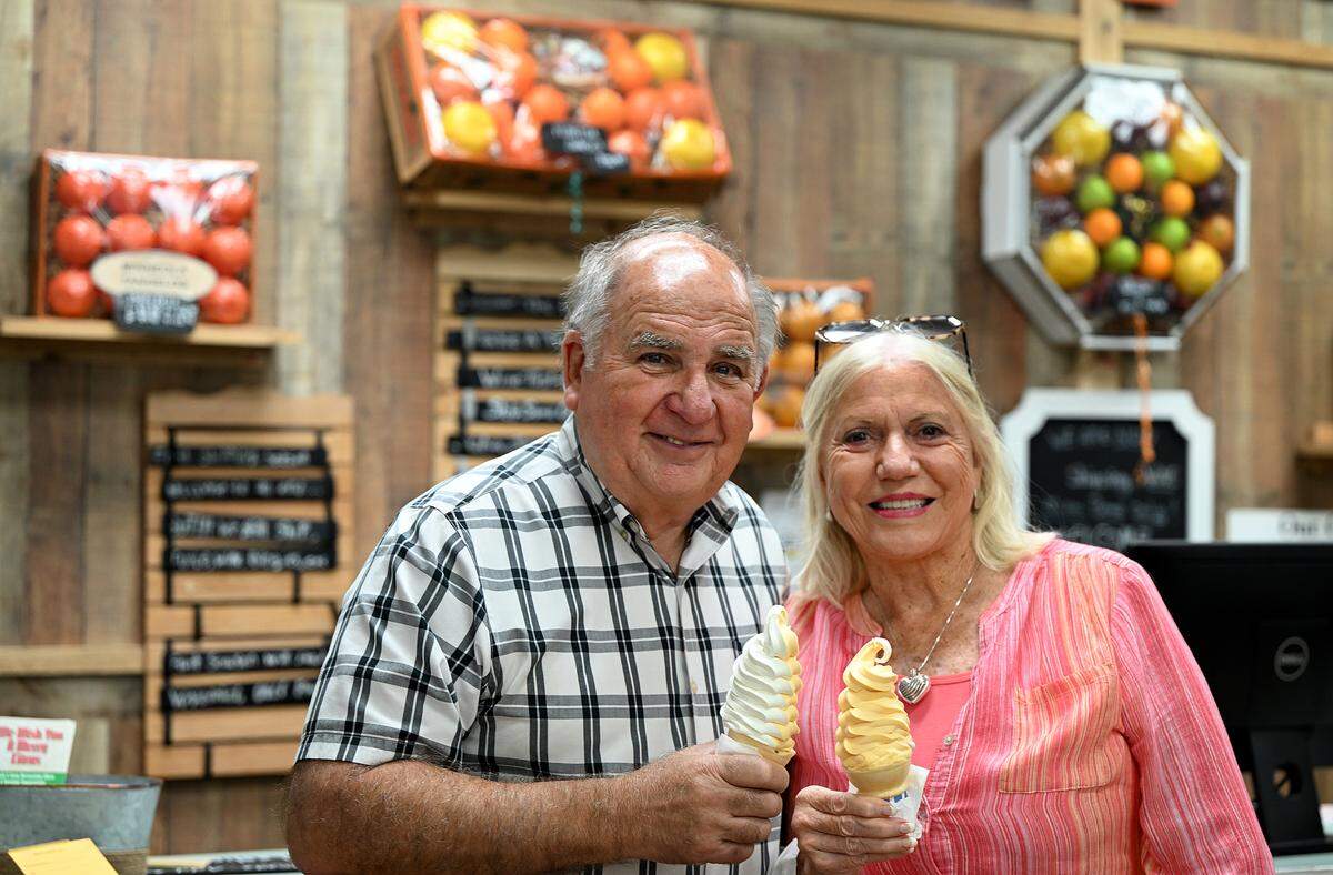 Dean and Janet Mixon hold ice cream cones at Mixon Fruit Farms on May 25, 2023.