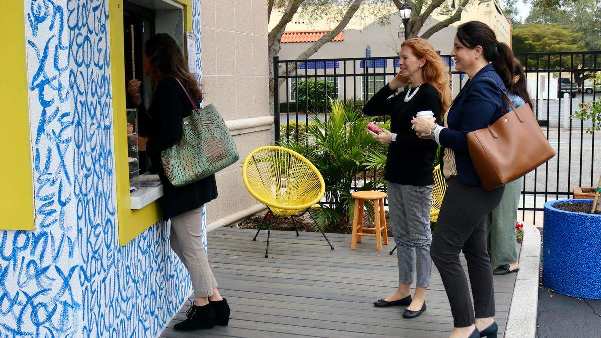 Customers line up to place their orders at the walk-up windown of Kefi Streetside Cafe, 1201 6th Ave. W., Bradenton on 2/8/2021.