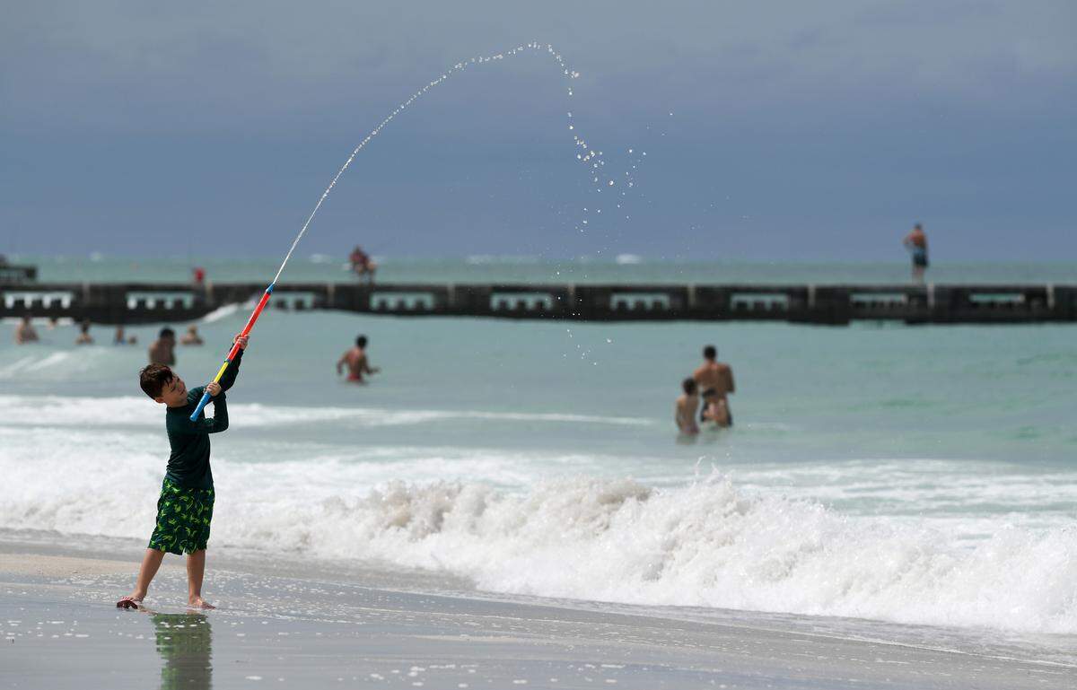 Jameson Watkins, 6, plays on Cortez Beach. Rain bands from a tropical disturbance impacting South Florida had not made their way to Manatee County beaches mid-morning Friday. The National Hurricane Center is forecasting the system to slightly strengthen into a tropical storm.