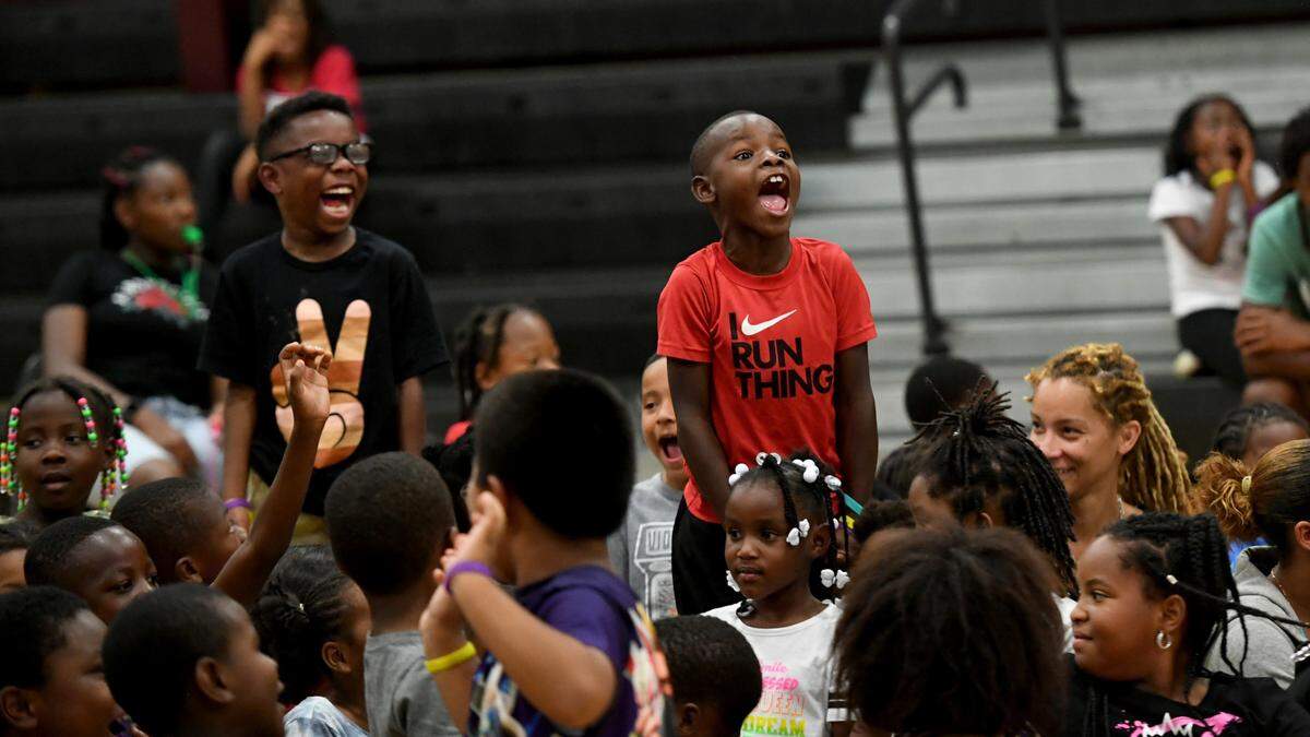 Children respond to author Vincent Taylor Friday at the 13th Av Center during a presentation encouraging audience participation. The Rosalyn Walton Education and Enrichment Services, Inc along with the 13th Avenue Dream Center is hosting the 6th Annual Juneteenth Reading Conference and Community Festival which continues Saturday.