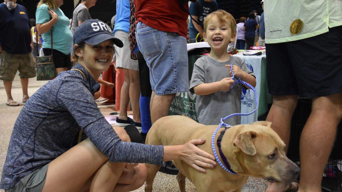 Audrey (left) and 3-year-old Grayson Hester pose for a photo with Pearl, shortly after adopting the 5-year-old dog at Manatee County Animal Service’s 5th Annual Adopt-A-Palooza on Saturday, Aug. 3 at the Bradenton Area Convention Center in Palmetto.