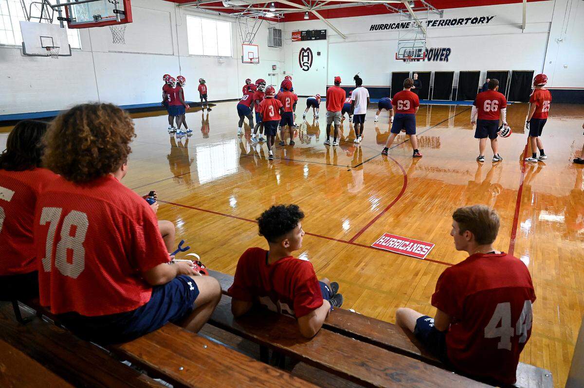 The Manatee Hurricanes High School football team practice indoors in the JROTC gym on the campus as the heat index pushed 94 outside.