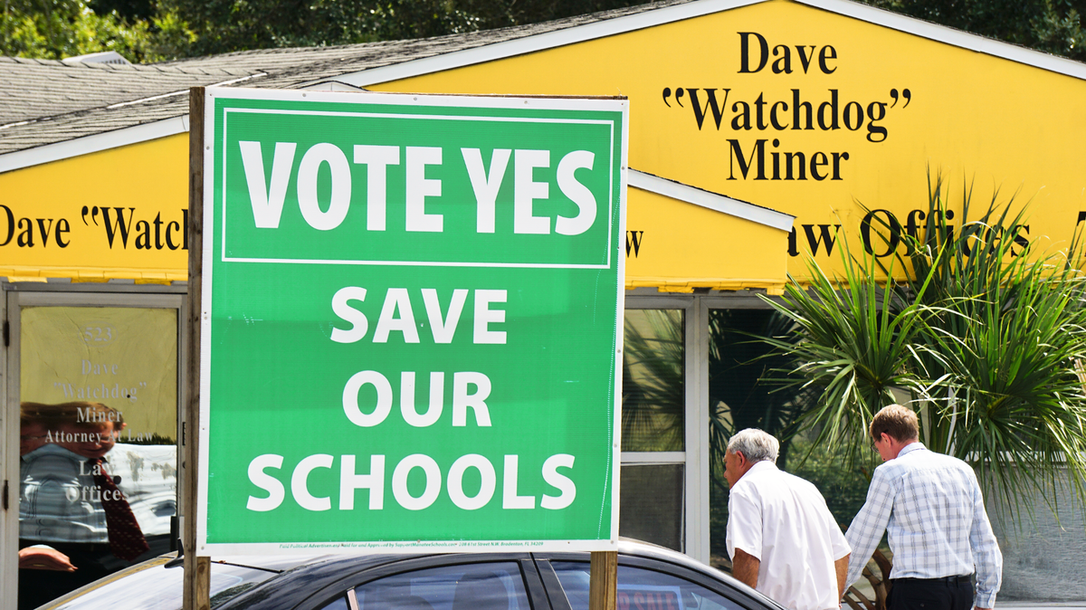 Former school board member Dave Miner promotes the renewal of the Manatee County School District’s 1-mill tax referendum outside of his law office in Bradenton.