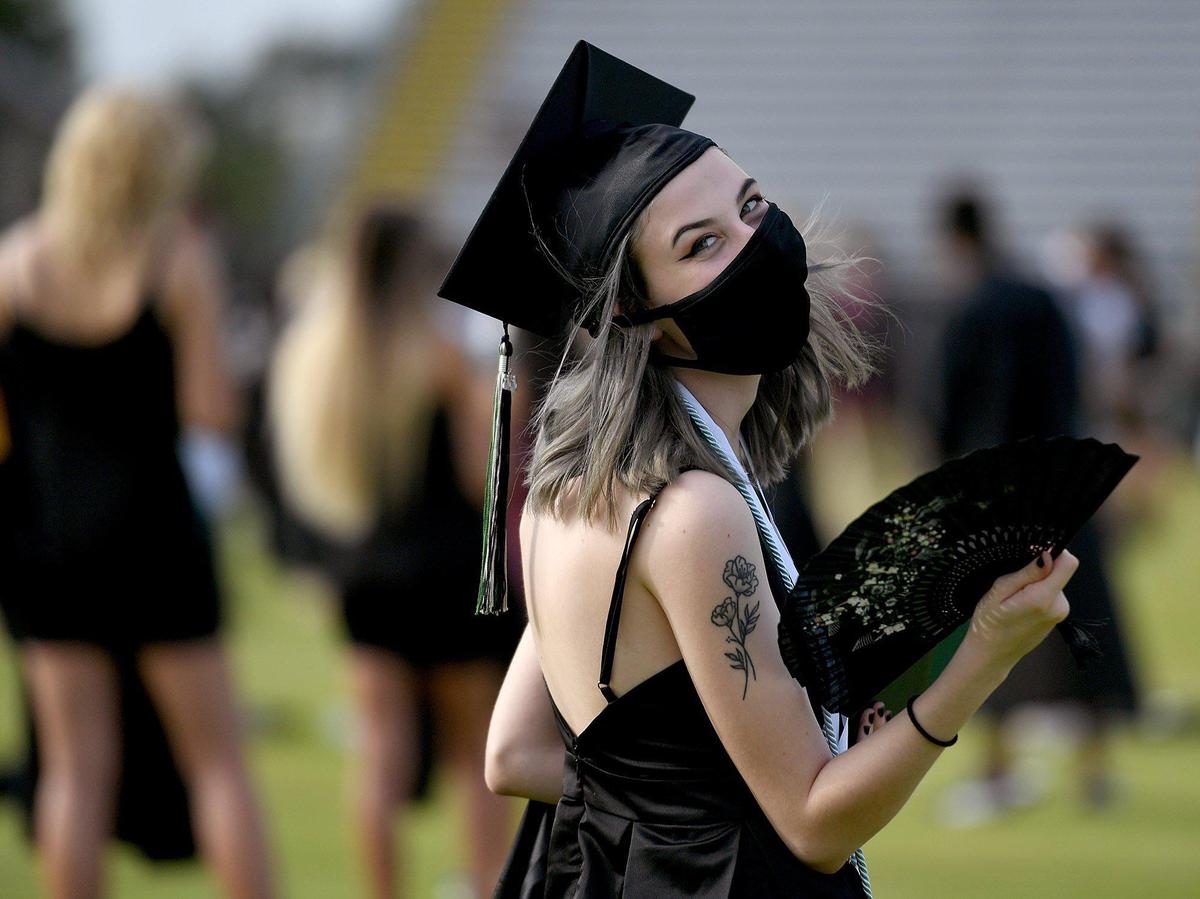 Gina Basilone waves a lacy fan at Lakewood Ranch High School’s class of 2020 commencement ceremony at LECOM Field Wednesday.