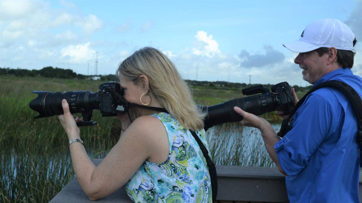 Linda and Jesse Waring snap photos of wading birds off of a dock at Celery Fields in Sarasota.