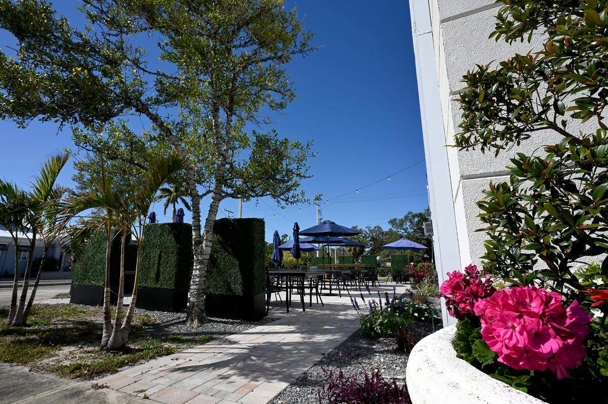 Flowers and privacy hedges surround the outdoor seating at Sofra Kitchen Bar & Bistro in downtown Bradenton.