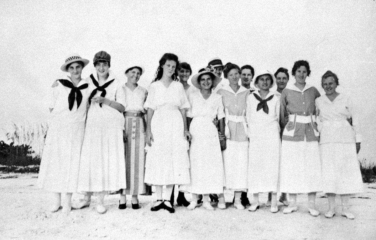 Girls gather for a picnic between 1915 and 1918 on the beach at Anna Maria Island. Left to right are Marian Braymer, Florence Zimmerman, unknown, Margaret Hurlebaus, unknown, Doris Hampton, Gertrude and Catherine Fuller, Julia Reasoner, Inez Morgan, Mabel Morrow, Pearl Keller and Grace Morgan. Notice that the girls all have their “summer whites” on.