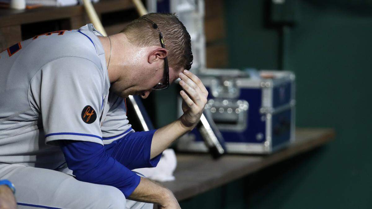 New York Mets relief pitcher Jacob Rhame sits on the bench after he was removed during the third inning of the team’s baseball game against the Washington Nationals at Nationals Park, Tuesday, July 31, 2018, in Washington. The Nationals won 25-4.