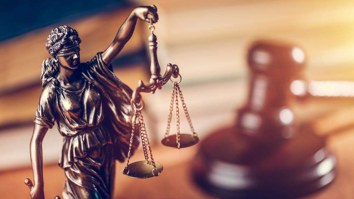 Law and justice concept - Themis statue, judge hammer and books. Courtroom.