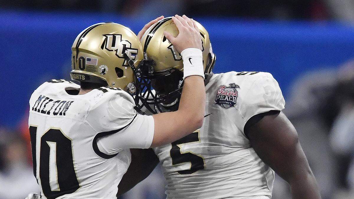 In this file photo, University of Central Florida quarterback McKenzie Milton (10) celebrates with Central Florida wide receiver Dredrick Snelson (5) during the second half of the Peach Bowl NCAA college football game against Auburn, Monday, Jan. 1, 2018, in Atlanta.
