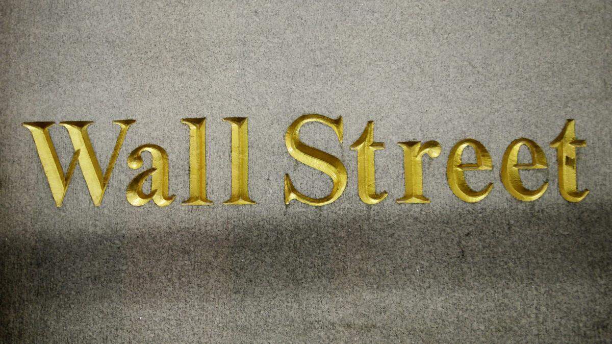 FILE - In this Oct. 8, 2014 file photo, a Wall Street address is carved in the side of a building in New York. Global stock markets dropped sharply Friday, Dec. 18, 2015, as a further falls in the the price of oil weighed on investor sentiment, eroding gains sparked the day before by the U.S. Federal Reserve's first rate hike in nearly a decade. (AP Photo/Mark Lennihan, File)