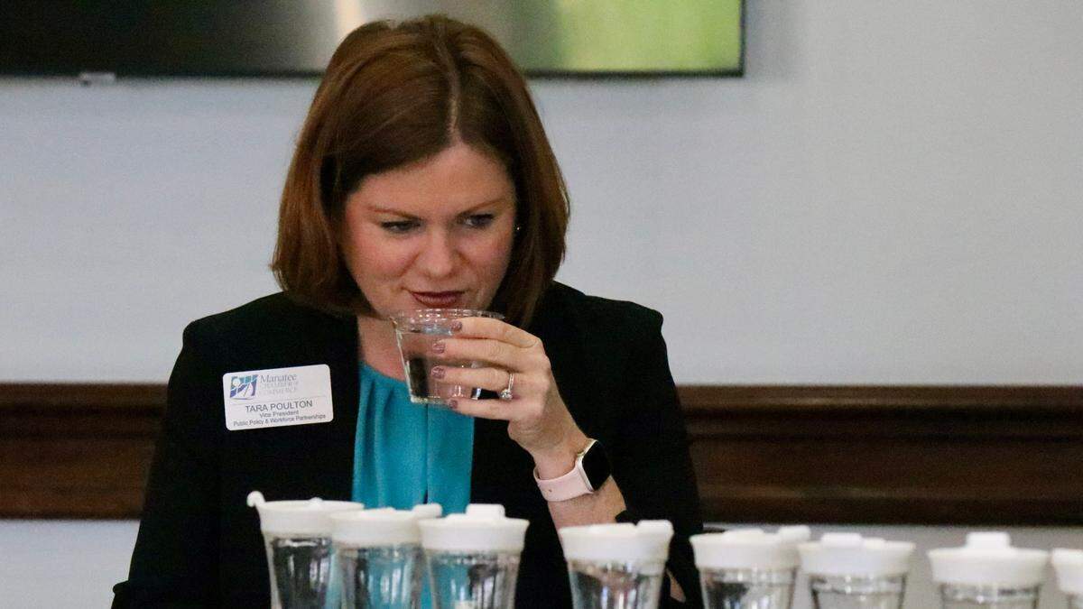 Tara Poulton tastes a cup of water during an annual drinking water competition March 25, 2022, among six regional water utilities.