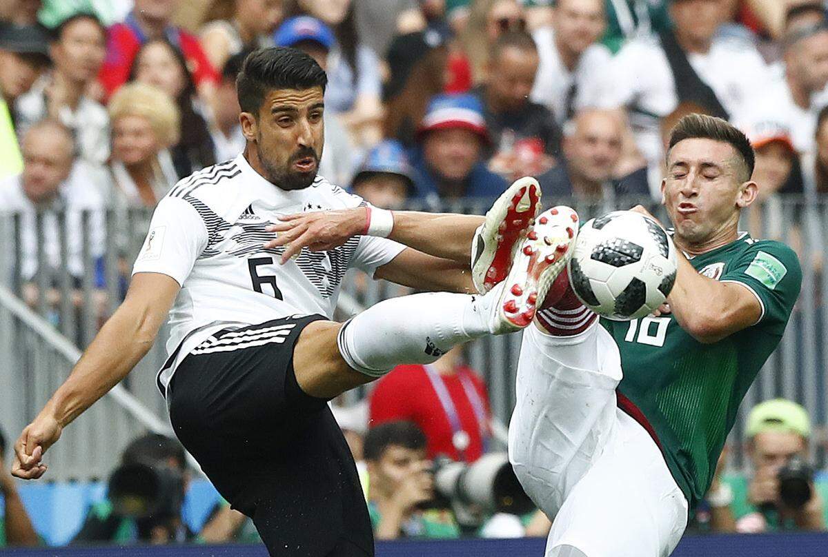 Germany's Sami Khedira, left, and Mexico's Hector Herrera challenge for the ball during the group F match between Germany and Mexico at the 2018 soccer World Cup in the Luzhniki Stadium in Moscow, Russia, Sunday, June 17, 2018. (AP Photo/Matthias Schrader)