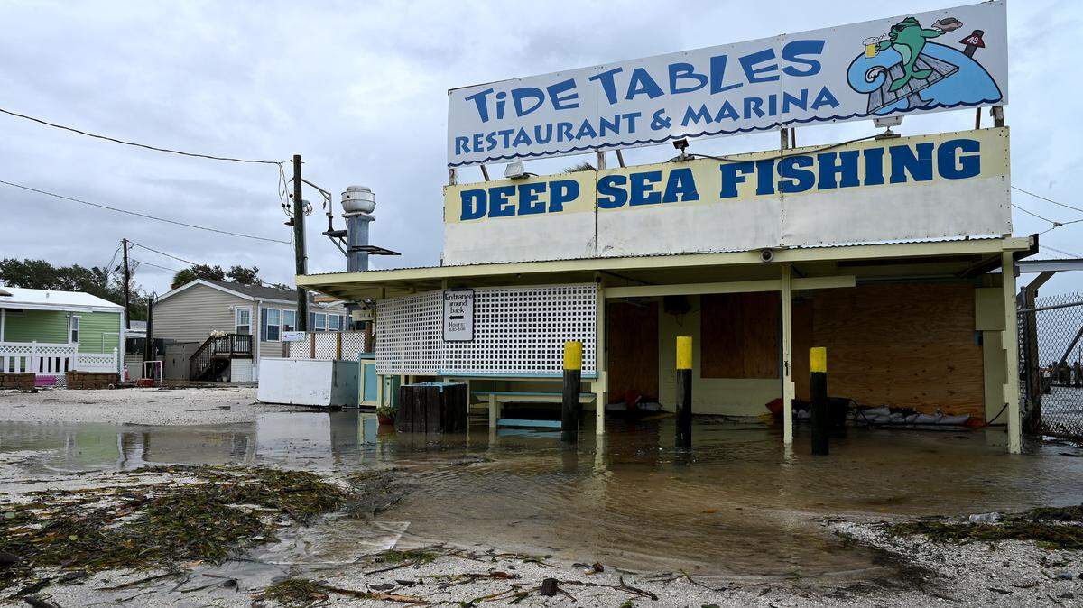 Waters swirl around Tide Tables at Cortez after Hurricane Idalia passed on August 30, 2023.