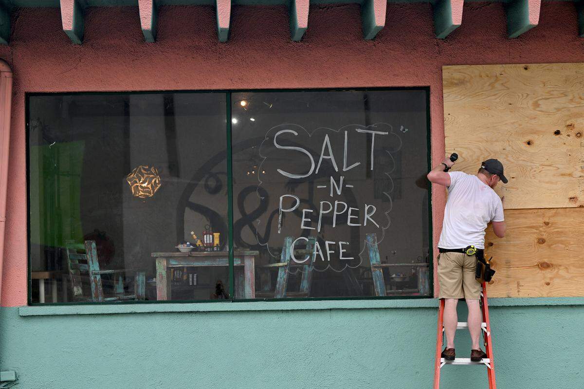 Matthew Smith boards up his restaurant in downtown Bradenton as Hurricane Idalia approaches on August 29, 2023.