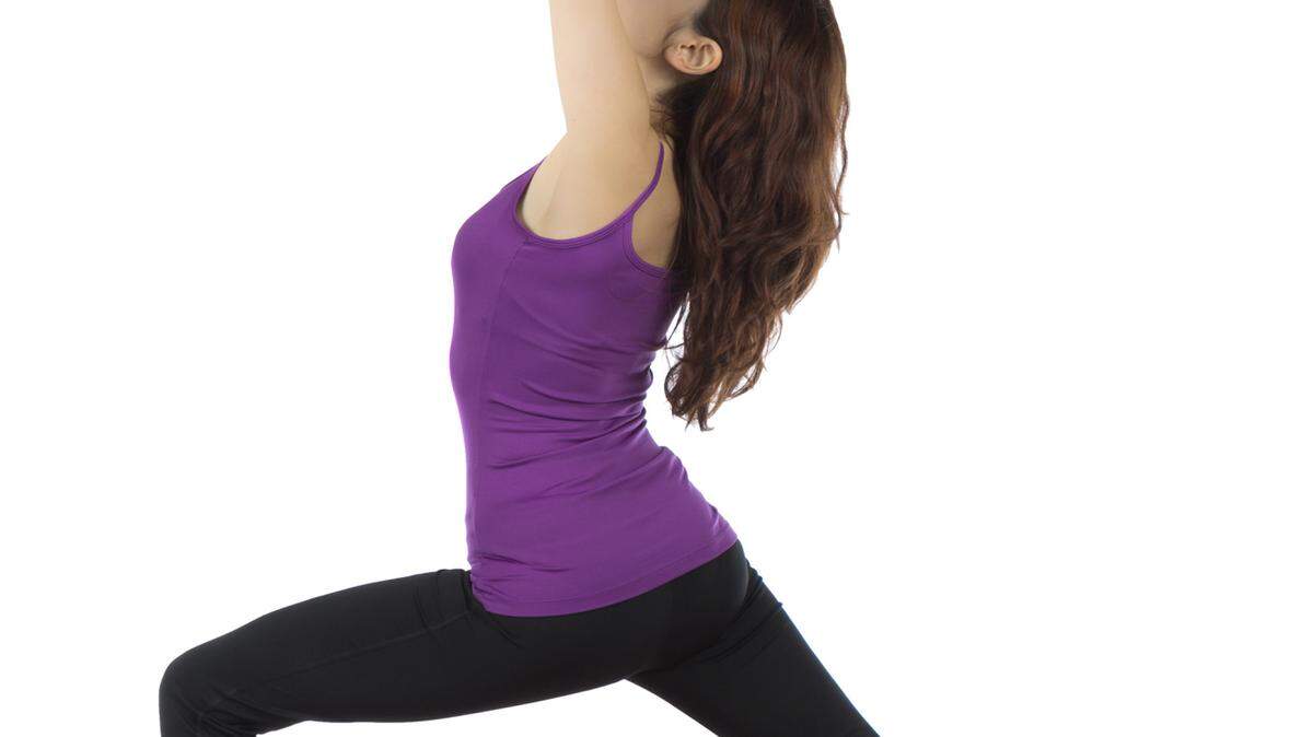 The Warrior I pose is a great stretch to increase your flexibility. Fotolia