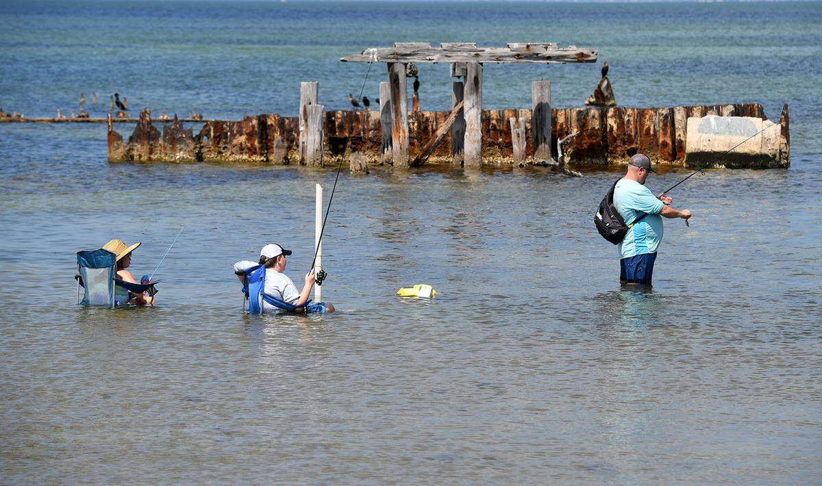 03/30/21--Site operators at Piney Point, the former phosphate mine, have begun a controlled release of up to 480 million gallons of contaminated water into a channel at Port Manatee due to a leak in a holding pond. A family fishes in the waters adjacent to the port.
