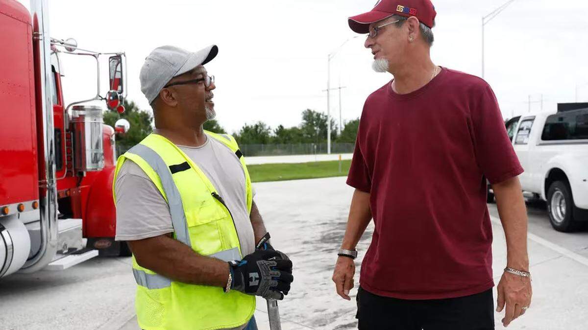 Miguel Vasquez, 54, a truck driver for more than a decade, left, talks to Christopher Mantei, 53, a truck driver with 27 years of experience, at a rest area along southbound Interstate 75 on Tuesday, June 20, 2023, in Ruskin.