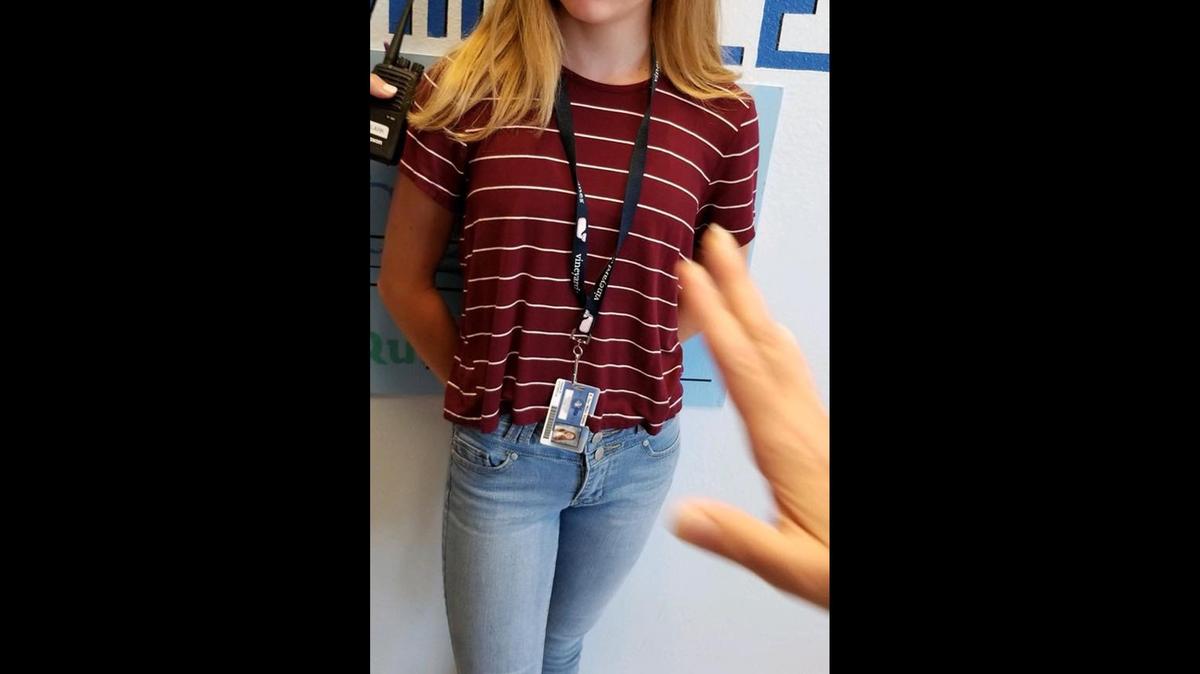 Jenna Barnhill, 12, was told to change her clothes by administrators at R. Dan Nolan Middle School after a bra strap was seen peeking out from the collar of her shirt on Aug. 23. Her mother, Christine, said the photo shows her daughter being nudged out of frame by Michelle Clark, the assistant principal.