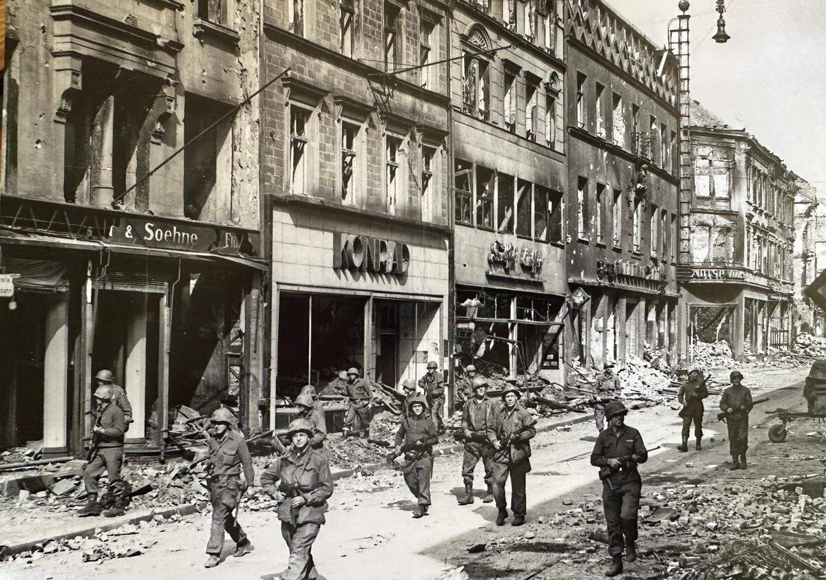 Soldiers of the U.S. Army’s 70th Infantry Division look for snipers as they move through the streets of Saarbrucken, Germany, during World War II.