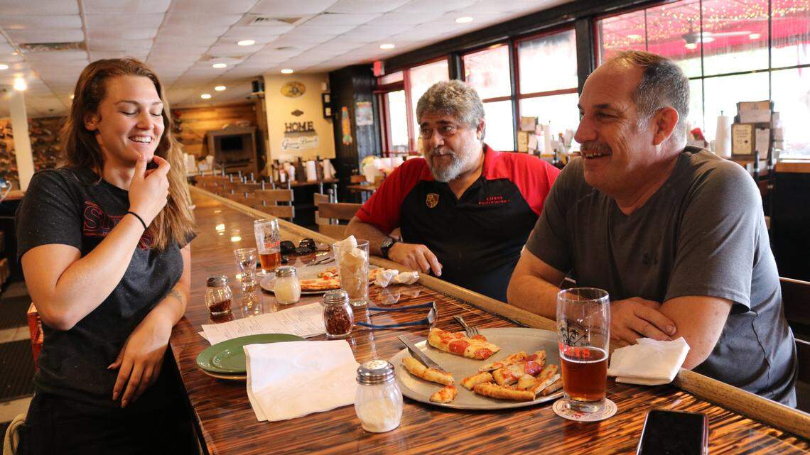 Bartender Brittany Douglas visits with guests Carlos Debonis, and Jeffery Bauer (right) at 3 Keys Brewing and Eatery.