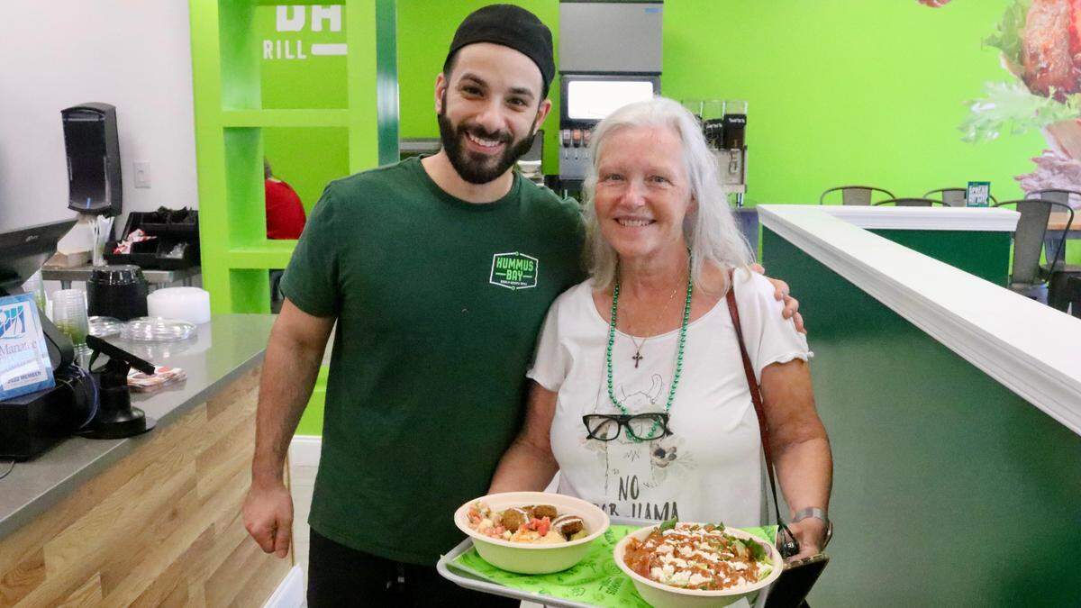 Mindy Hill of Parrish, shown with Hummus Bay owner Sam Dartawil March 17, 2022, ordered a tabouleh salad and a falafel wrap.