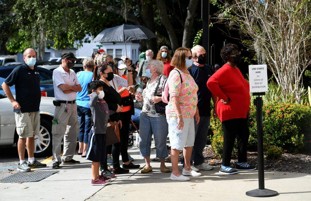 01/05/22—Hundreds were in line at the Central Branch library at noon. Manatee County was distributing 7,500 rapid at-home COVID-19 kits which were supplied by the Florida Department of Health at the county libraries.