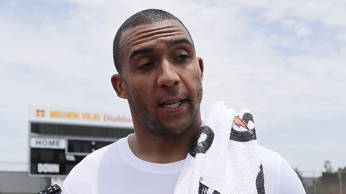 In this July 12, 2013 file photo, New York Jets tight end Kellen Winslow Jr. talks to reporters after a workout organized by quarterback Mark Sanchez in Mission Viejo, California. Winslow has been arrested on charges of rape and other sex crimes on the day he was to appear in court on an unrelated burglary charge.