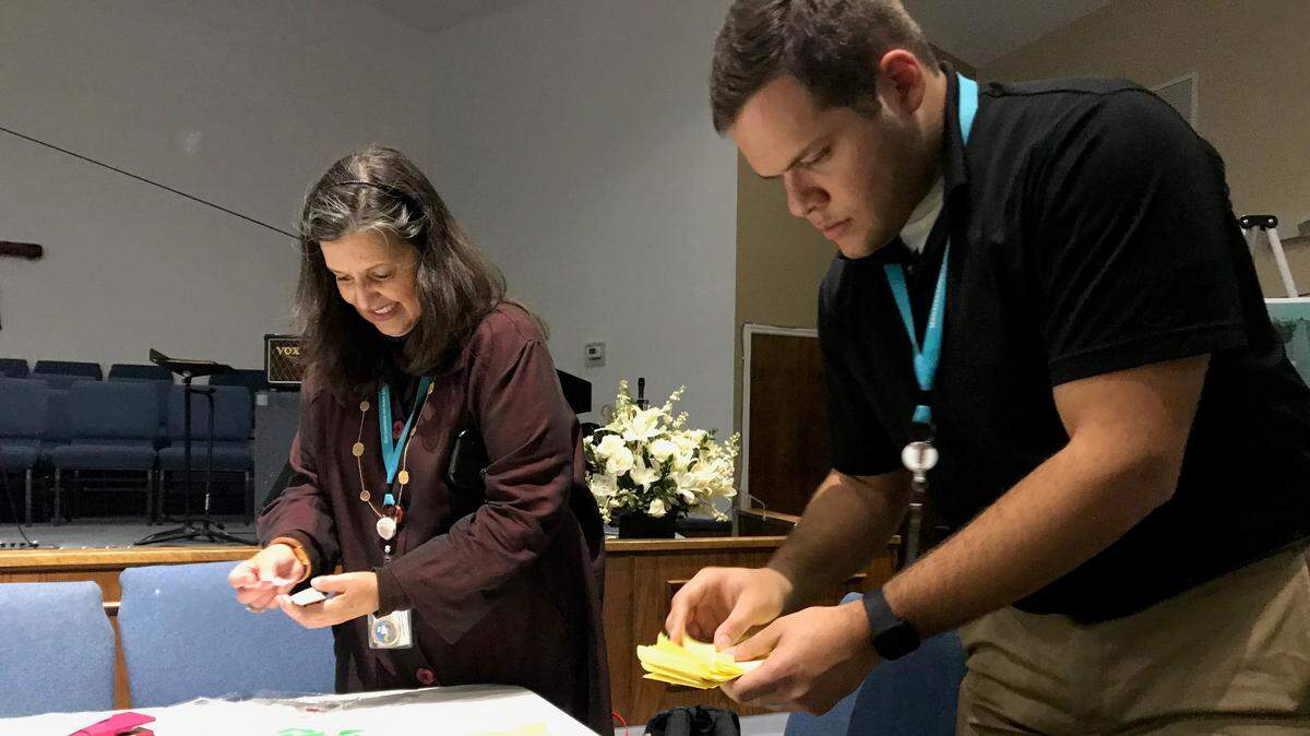Debbie DeLeon and Xavier Colon of Manatee County Neighborhood Services collect votes from Parrish residents on issues they see in the redevelopment of the heart of their village.